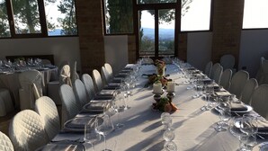 A long dining table set for a formal meal with chairs, wine glasses, and candles. - Seventeenth-century Villa Giulia with panoramic swimming pool, +15 beds ((PERUGIA))