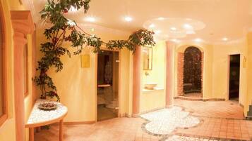 Experience a serene atmosphere in our inviting corridor, featuring a decorative tile pattern and a tranquil spa area.