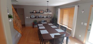 Enjoy meals with family and friends in this dining area, featuring a long table and six chairs.