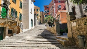 A narrow stone staircase leading up a hill, flanked by colorful buildings with balconies and shutters. - Wonderful, secluded, minutes from the beach, with 5 bedrooms (Labin)