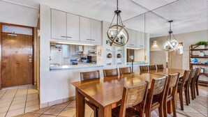 A modern kitchen with white cabinets, a built-in microwave, and a breakfast bar. - Stunning Oceanfront, 2BR/2BA, Gorgeous Ocean & Mt. Views, Premium A/C (Kihei)