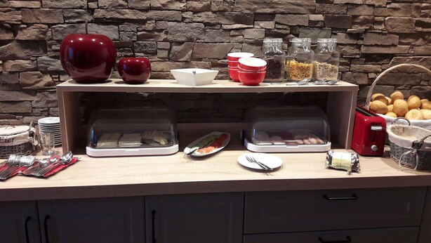 A breakfast buffet setup with various food items and utensils. - Zum Goldenen Löwen (Moosbach)