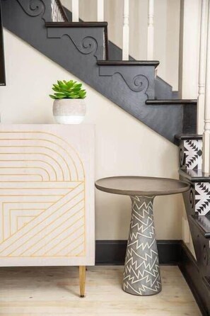 A staircase with dark railings and a white wall. - Boho Lux (Atlanta)