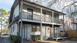 A two-story building with a balcony on the ground floor and a second-floor balcony. - Boho Lux (Atlanta)