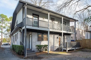 A two-story building with a balcony on the ground floor and a second-floor balcony. - Boho Lux (Atlanta)