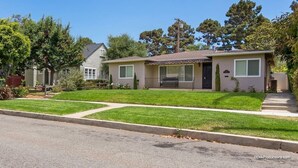 A single-story house with a front porch, a small attached garage, and a well-maintained lawn. - Perfect Location | Fantastic Home | Near Beach! (Oceanside)