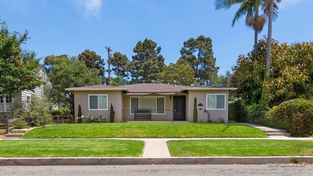 A single-story house with a front porch, a small front yard, and a palm tree to the right. - Perfect Location | Fantastic Home | Near Beach! (Oceanside)