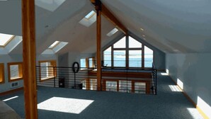 A high-ceilinged attic room with skylights, a wooden bench, and a view of the sea. - AMAZING OCEAN VIEW LUXURY Beach Home           !The Skyscraper!  Netarts (Netarts)