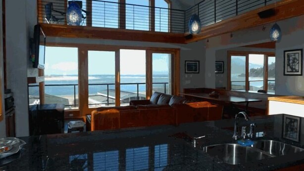 A spacious kitchen with large windows, a dining area, and a view of the ocean. - AMAZING OCEAN VIEW LUXURY Beach Home           !The Skyscraper!  Netarts (Netarts)