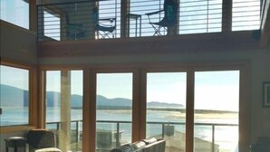 A spacious living room with large windows offering a view of the sea and mountains. - AMAZING OCEAN VIEW LUXURY Beach Home           !The Skyscraper!  Netarts (Netarts)