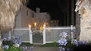 A gated entrance to a building with a staircase leading to the upper floors. - Chic Beach Apartment..Steps to the sand! (San Diego)