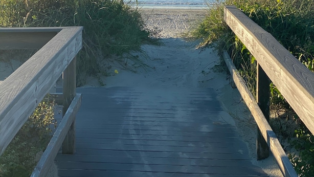 A wooden boardwalk leading to a beach with a sign indicating 'Sand Dune Lane'. - Sea Salt Cottage - Beach front neighborhood, next to downtown restaurants (Isle of Palms)