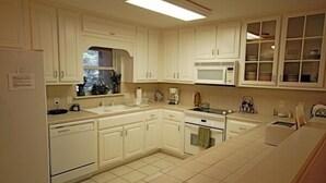 A kitchen with white cabinets, a microwave, a coffee maker, and a dishwasher. - Stylish Townhome by K&P Hotel - LABOR DAY SPECIAL, 5 for 4; 4 for 3.5 (St. Simons Island)