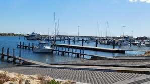 A marina with boats docked at wooden piers.