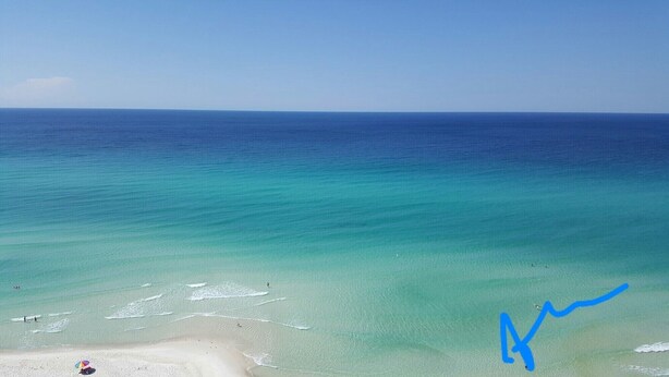 A beach with clear turquoise waters and a sandy shore. - ENTIRE TWO-STORY FRONT BEACH RD HOME PRIVATE POOL & PARKING HUGE BALCONY DECKS (Panama City Beach)