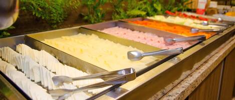 A buffet with various food items and serving utensils.