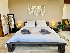 A bed with white linens, two pillows, and two folded blankets. - Comfortable freestone house, incredible view, 3 large bedrooms ... (Porto-Vecchio)