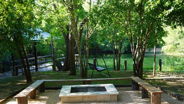 A park with a fire pit, benches, and a swing set. - Country-style Oasis! The perfect family get-away. VIEW OUR VIDEO!  (San Antonio)