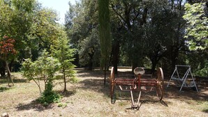 A rustic outdoor area with a metal chair and a swing set. - From the Piero hill you can admire the Valtiberina where Tuscany and Umbria merge (Sansepolcro AR)