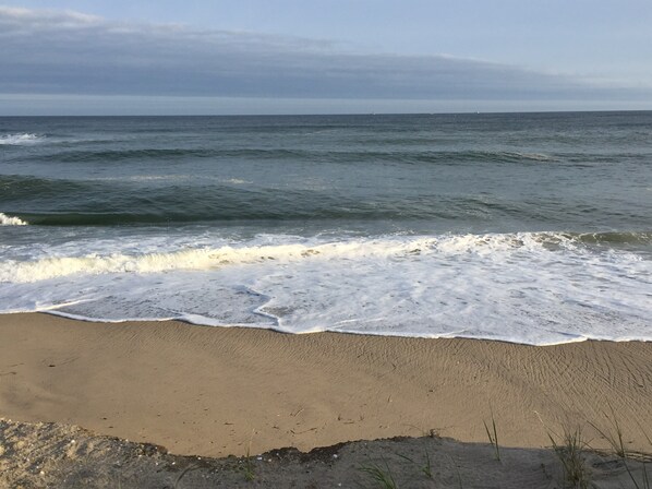 A beach with waves approaching the shore.
