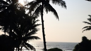 A beach view with palm trees and the ocean. - Whispering Ocean (Panadura)