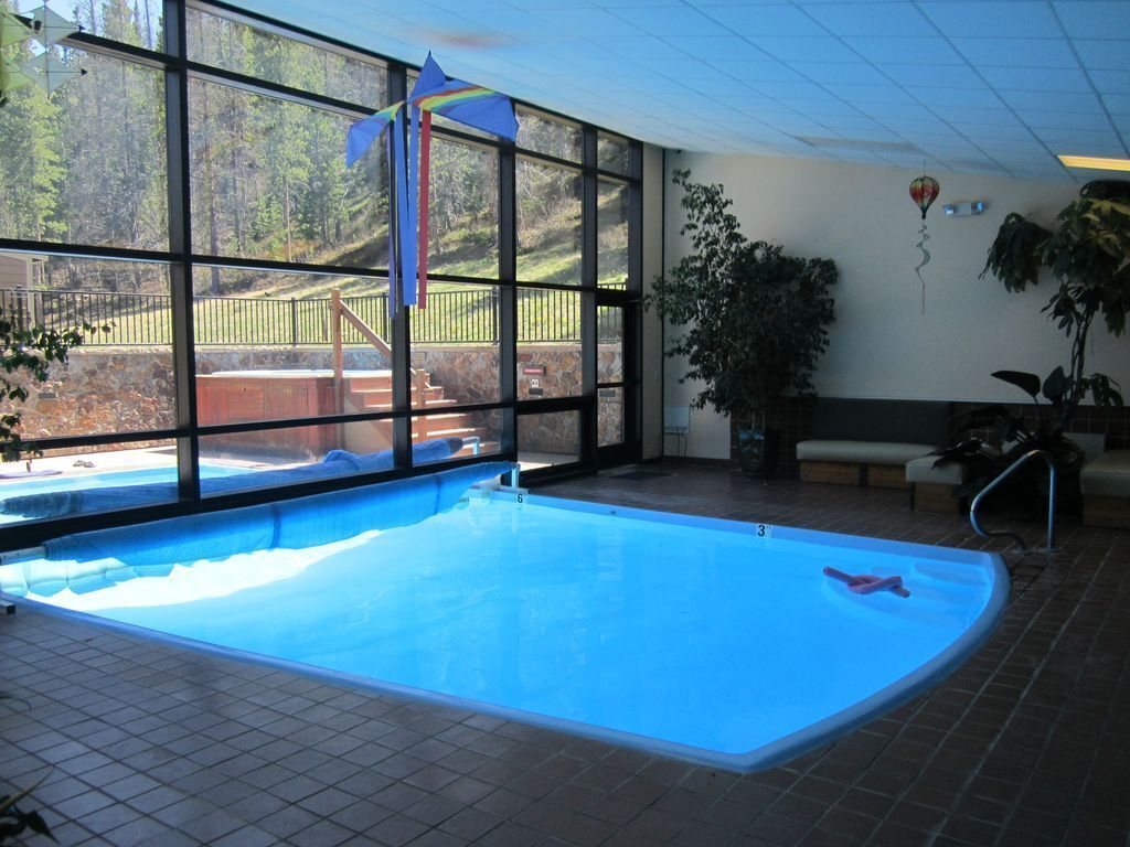 Pool has inside and outside portion and indoor and outdoor hot tubs.
