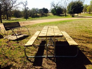 Une table de pique-nique avec des bancs dans un parc.