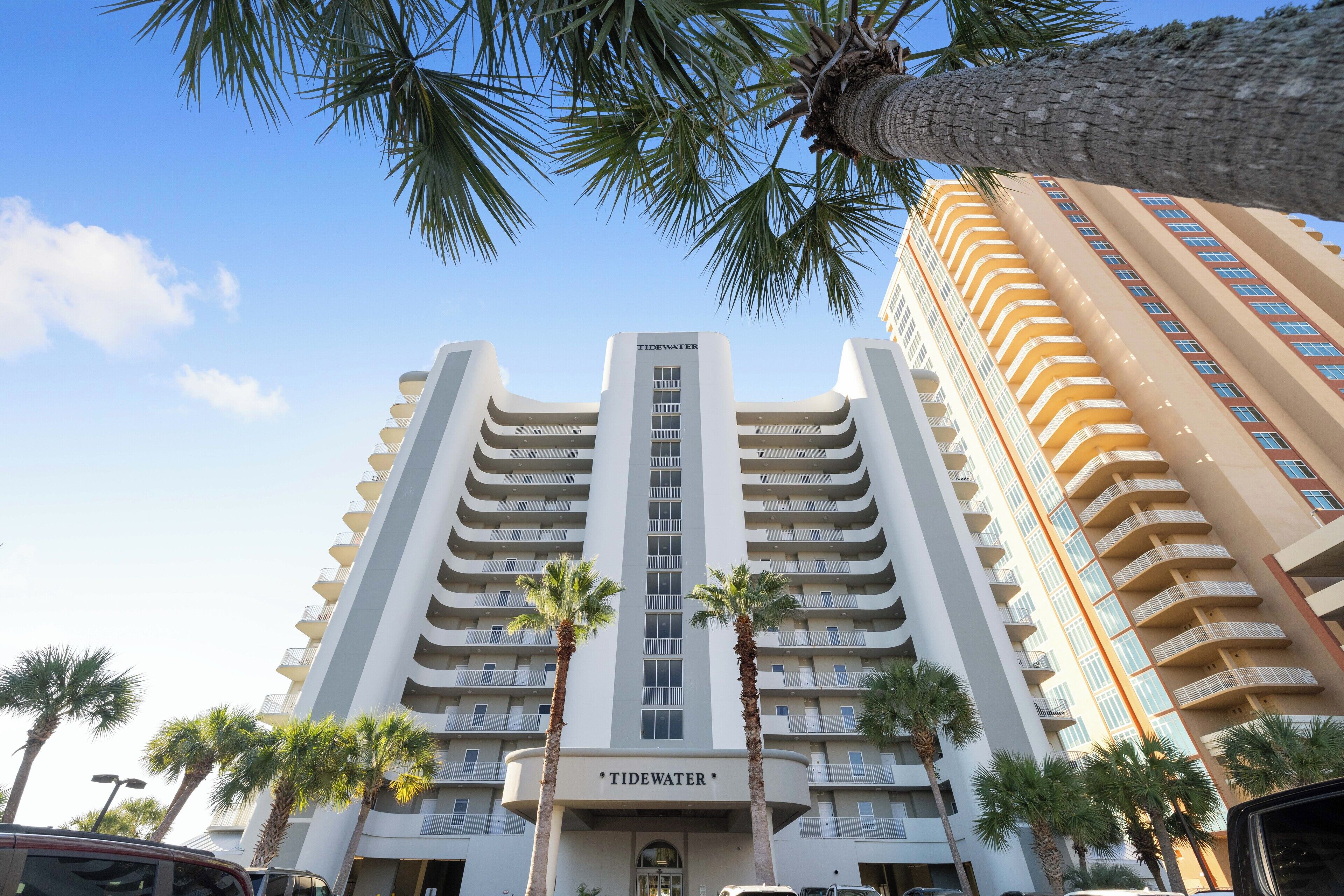 A multi-story hotel with a central vertical sign reading "Tidewater."