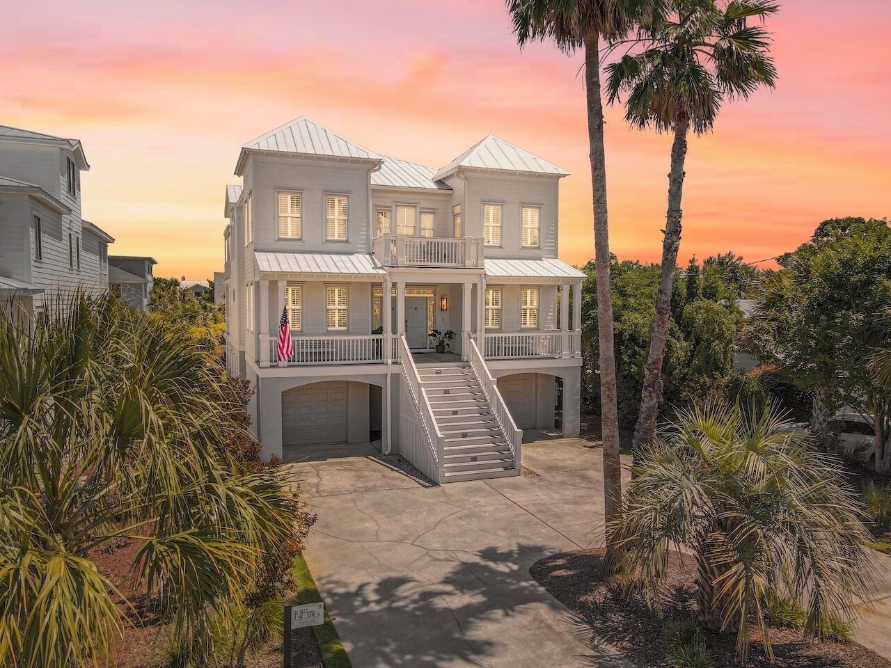 A multi-story house with a central staircase, a front porch, and a garage.