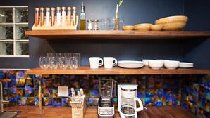 A kitchen with wooden shelves, a coffee maker, a blender, and various kitchen utensils. - Private Guesthouse in Central Phx--Beaker Bunker (Phoenix)