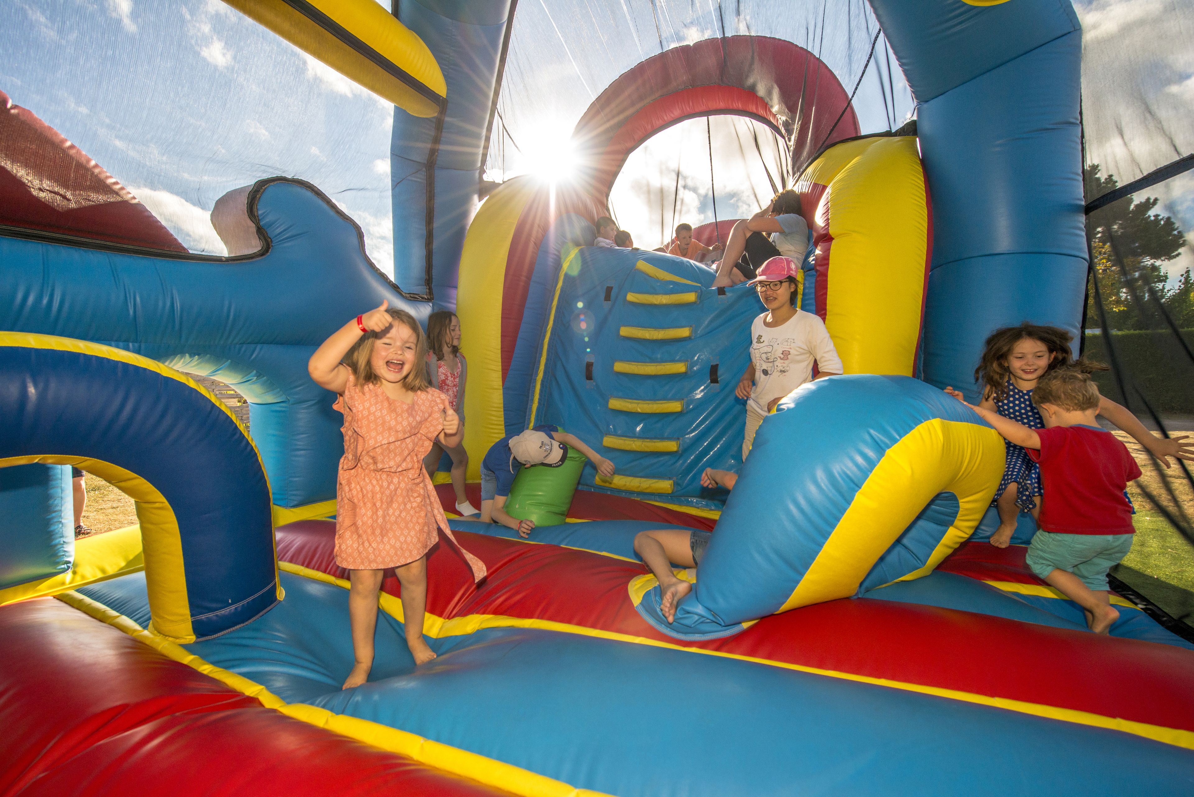 An inflatable play area with slides and tunnels.