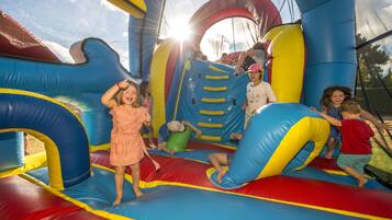 An inflatable play area with slides and tunnels.