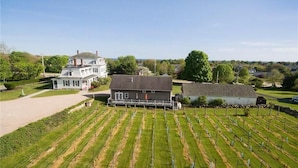 A large estate with a main house, a barn, and extensive green fields. - Langworthy Inn (Westerly)