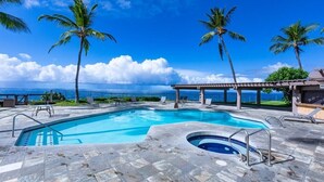 A swimming pool with a view of the ocean, surrounded by palm trees and lounge chairs. - OCEANFRONT 3+2.5 AC Pickleball Onsite! Walk to Keauhou Bay & Kahaluu Beach Park (Kailua-Kona)
