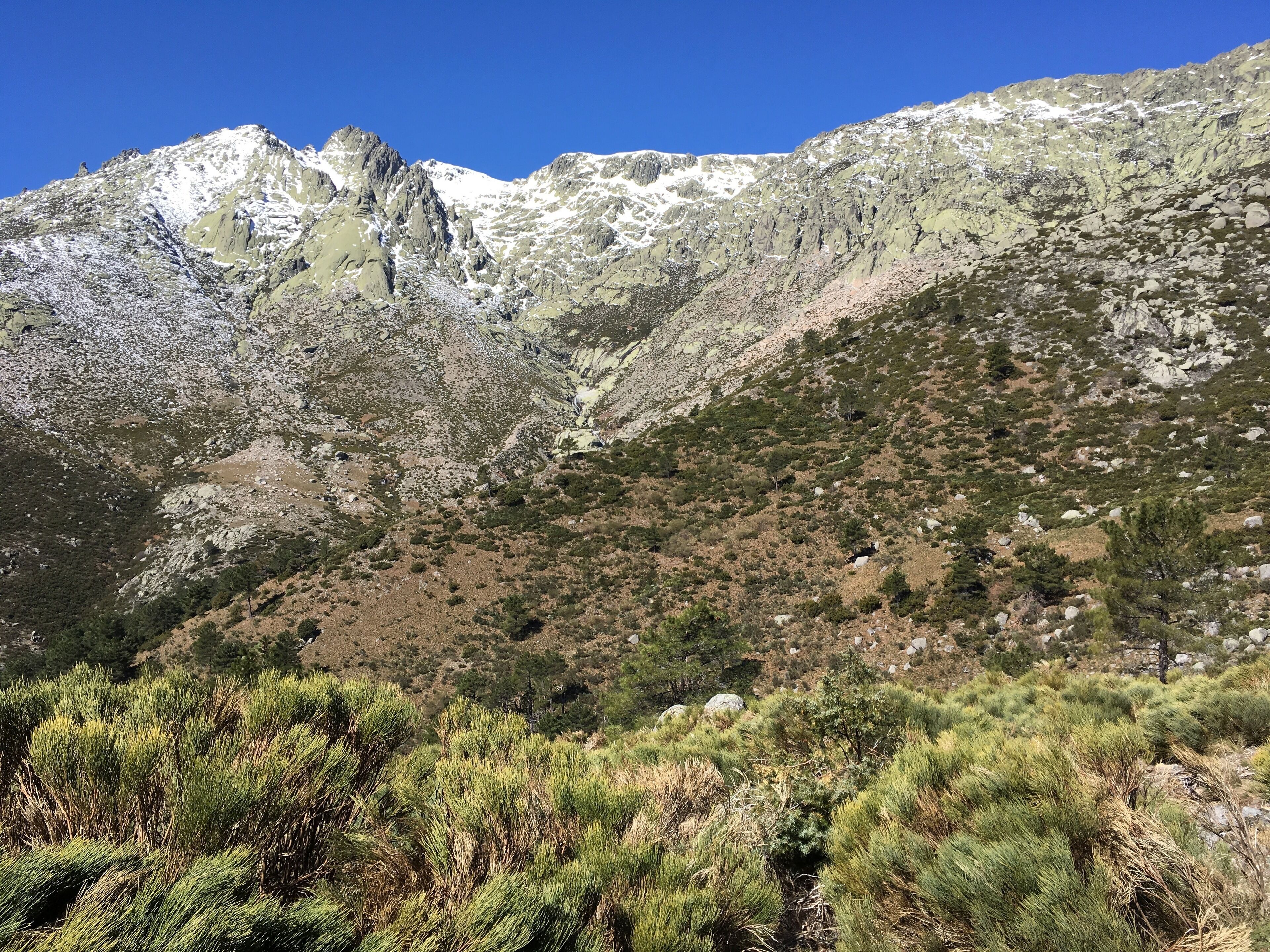 A mountainous landscape with rocky terrain and sparse vegetation.