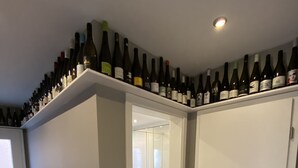 A room with a wine rack on the ceiling, a shower, and a door leading to another room. - Bed 'n Riesling - The vacation apartment in Forst a.d. Wine route with its own garden (Forst an der Weinstraße)