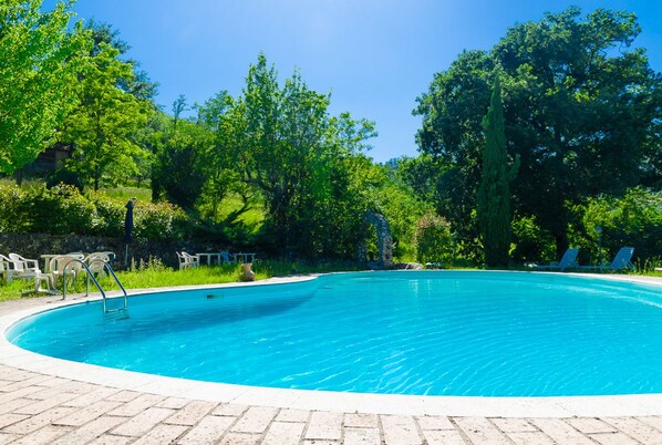 Outdoor pool, open 9:30 AM to 7:00 PM, pool umbrellas, pool loungers