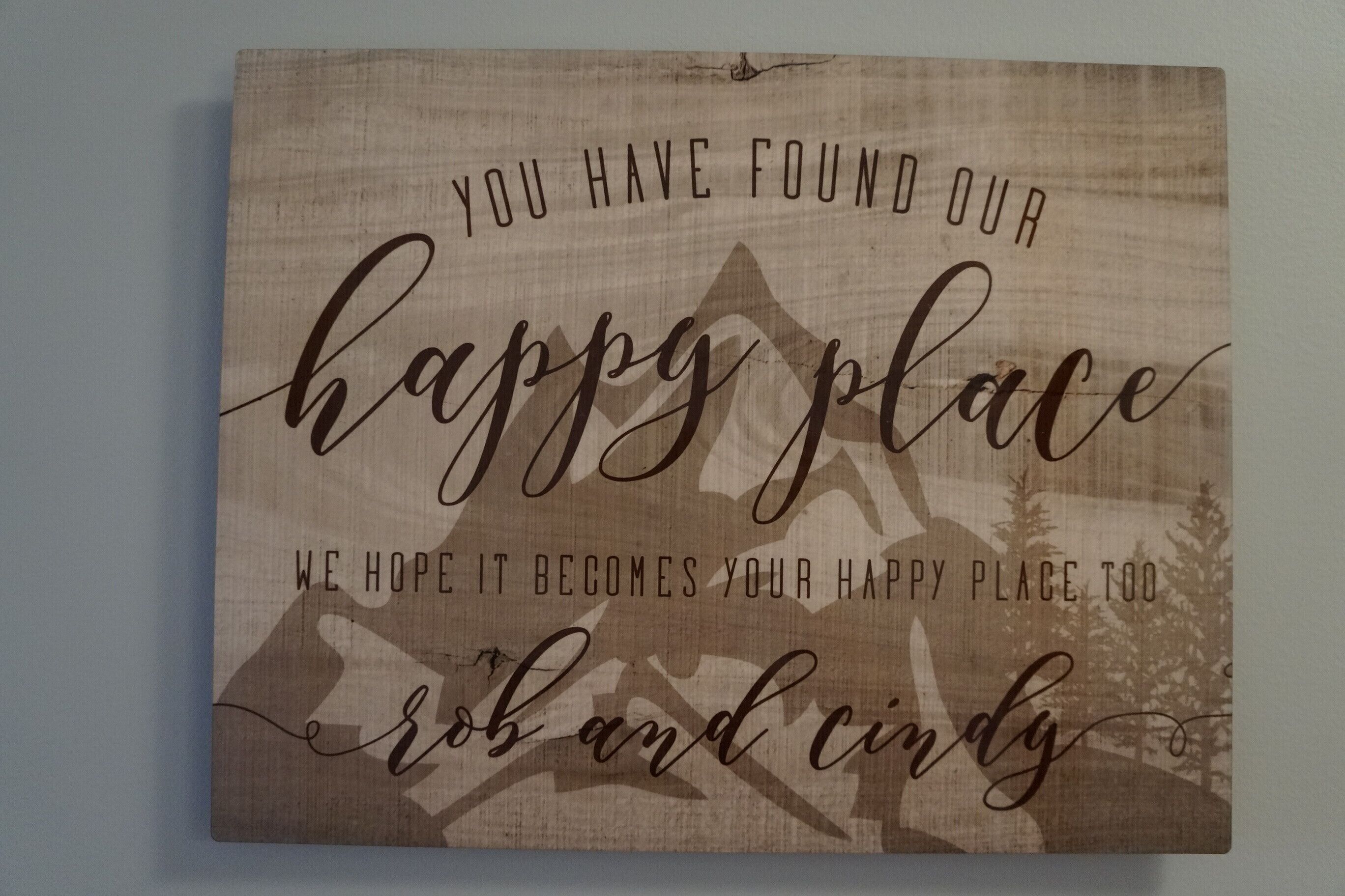 A framed sign with text and a mountain silhouette.