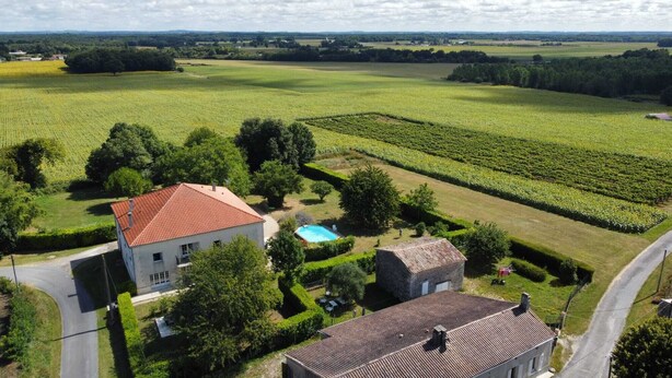 A rural property with a large field, a swimming pool, and a house with a red roof. - Large luxury Villa located in beautiful countryside close to shops (Saint Ciers du Taillon)