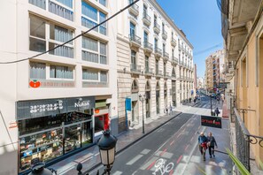 A street view with a building featuring a storefront labeled "Tomate Rooms" and a sign for "Nukal". - Tomate Rooms (Alicante)
