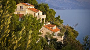 A coastal property with multiple buildings, a balcony, and a view of the sea and mountains. - Enjoy Your Front Row Villa On The Adriatic Sea (Pisak)
