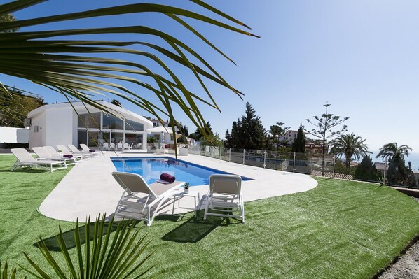 A heated pool, sun loungers