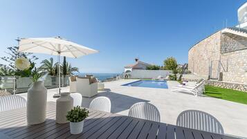 A heated pool, sun loungers