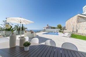 A heated pool, pool loungers