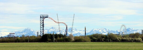 A roller coaster with a mountainous backdrop.