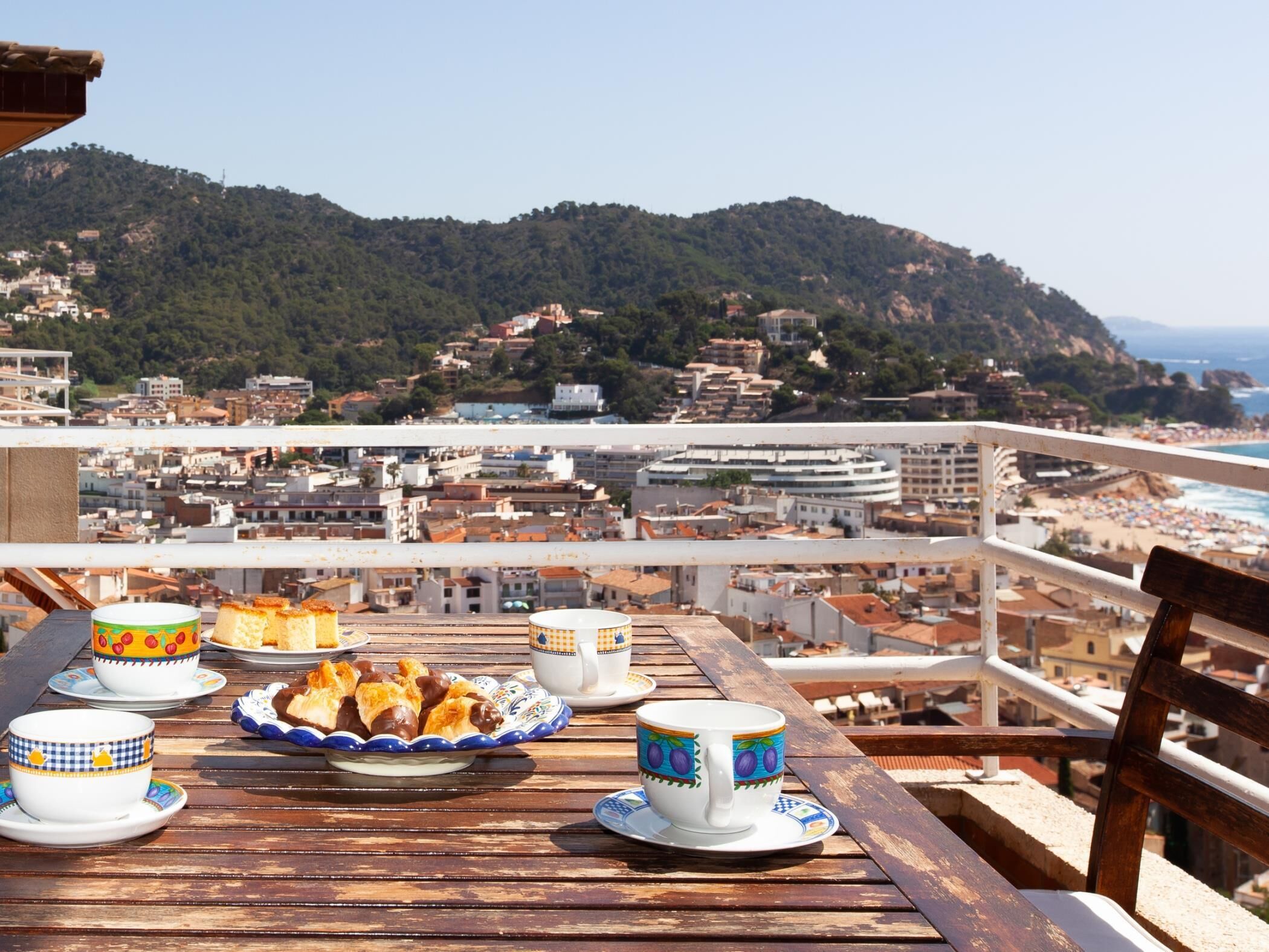 A table with a view of a coastal city, including buildings and a beach.