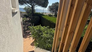 A view from a balcony with a stone staircase leading to a patio area.