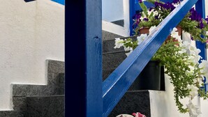 A blue metal staircase with handrail, leading to a door.