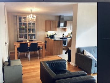 Open plan lounge, kitchen and dining area.