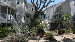 A row of white two-story buildings with balconies and a central tree. - Key West Style Townhome  Intercoastal Waterviews!!!
 (Indian Rocks Beach)
